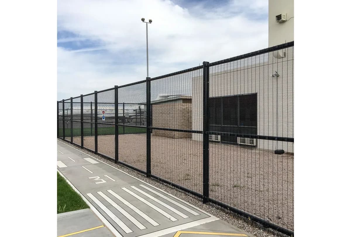 Close view of black 358 anti-climb welded mesh fencing at a secured facility